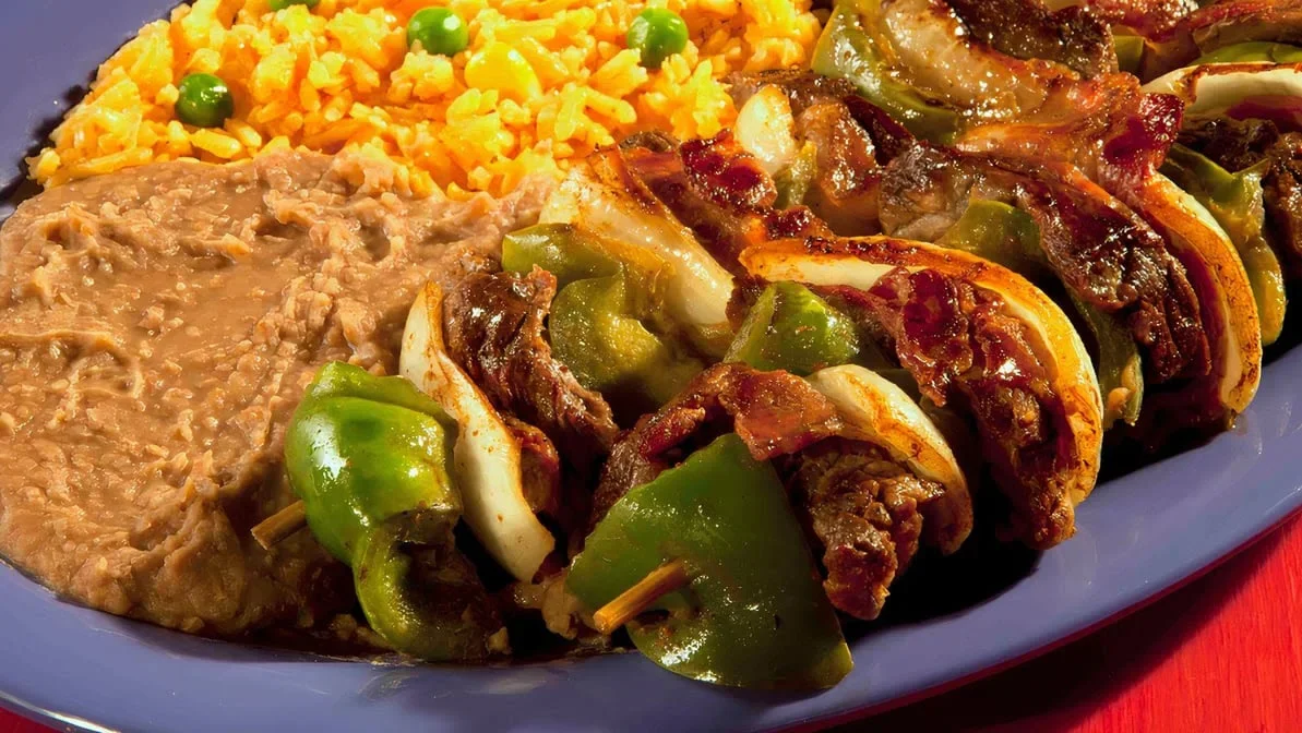 Alambres - Grilled meat with peppers, onions, and melted cheese